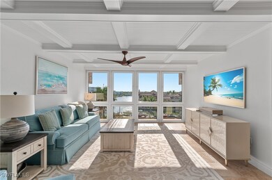 Living room featuring a ceiling fan, light wood-ty