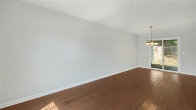 Empty room with a chandelier, dark wood finished f