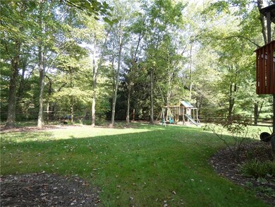 Nearly level, the rear yard offers plenty of sprawling landscape for entertainment and playtime.