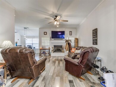 Living room with ceiling fan, ornamental molding, 