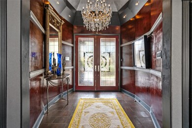 A stunning entryway featuring elegant glass doors