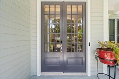 Love the tall and stately front doors...