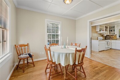 Dining space featuring ornamental molding and light wood-style floors