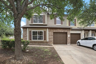 View of front of house featuring driveway, brick 