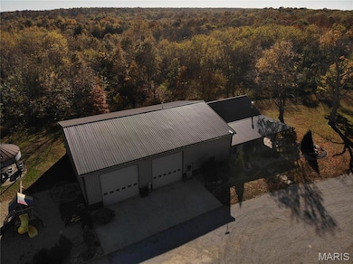 View from above of property with a heavily wooded area