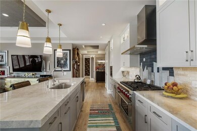 Kitchen featuring high end stainless steel range, 