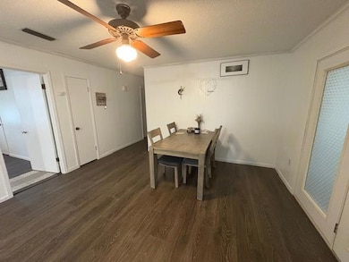 Dining area featuring wood finished floors, ceiling fan, a textured ceiling, and baseboards