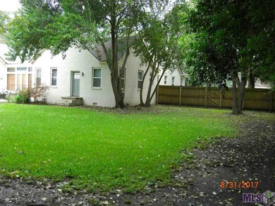 Lots have been surveyed/staked, tree line at rear 