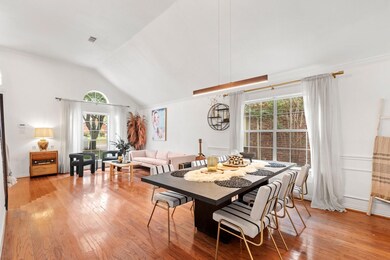 Dining space with lofted ceiling and hardwood / wo