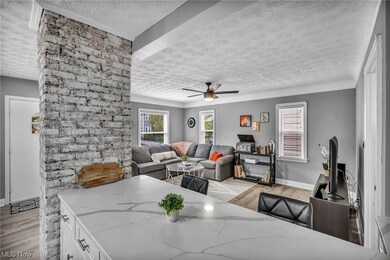 Living room with light wood-type flooring, ceiling fan