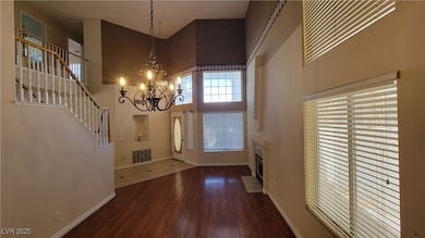 Entryway featuring a high ceiling, a chandelier, w