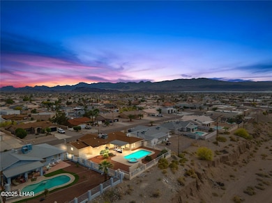 Aerial view at dusk featuring a mountain view and