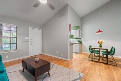 Living area with a ceiling fan, light wood finish