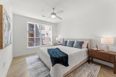 Bedroom with light wood-type flooring, ceiling fa