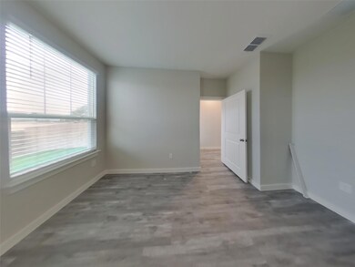 Spare room with baseboards and wood finished floo