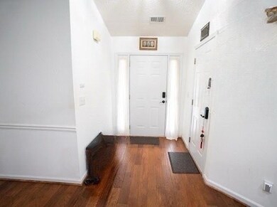 Entrance foyer featuring wood finished floors and baseboards
