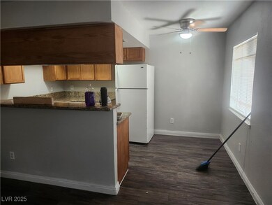 Kitchen featuring freestanding refrigerator, a cei