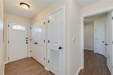 Foyer entrance featuring visible vents, baseboards