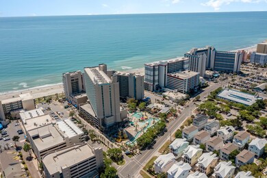 Aerial view featuring a beach view and a water vie