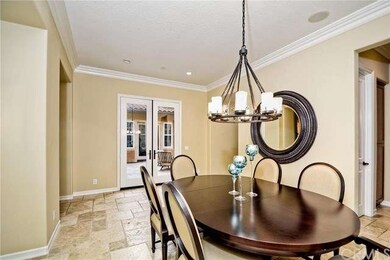 Formal dining room looks out through french doors 