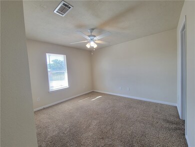 Unfurnished room featuring ceiling fan, carpet, an