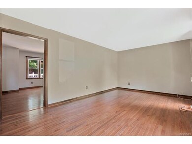 Family room with wood floors and a coat closet.