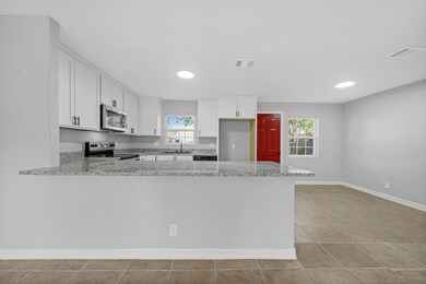 The kitchen overlooks the living room by way of the island and breakfast bar.