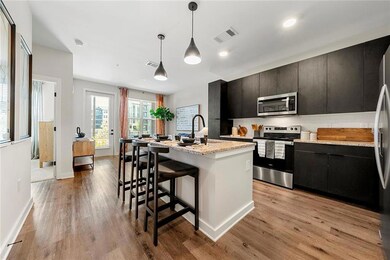 Kitchen featuring stainless steel appliances, dark