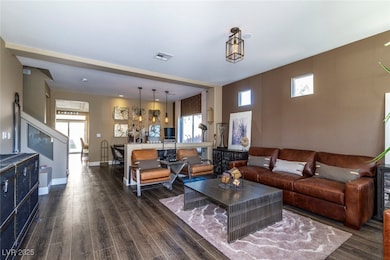 Living room with plenty of natural light and dark wood-style flooring