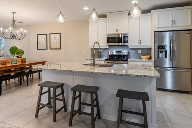 Kitchen with upgraded white cabinetry, quartz coun
