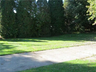 Land. Back view of the yard...privacy hedge to nei