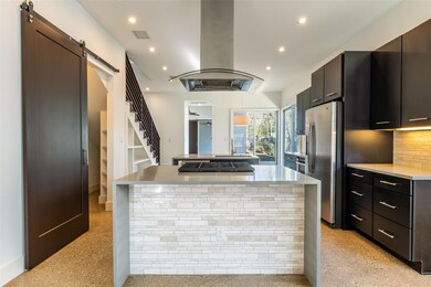 Kitchen featuring island range hood, a center isl