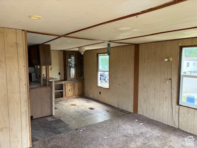 Kitchen with plenty of natural light and wooden walls