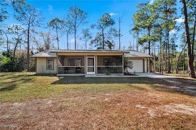 View of front of home with a front lawn, a garage,