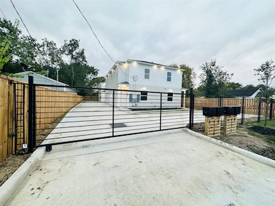 Modern two-story home with a gated driveway for ad