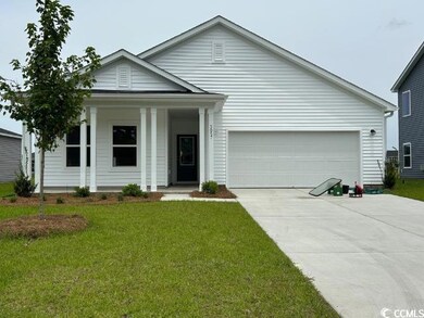 Ranch-style house featuring concrete driveway, an attached garage, a front lawn, and a porch