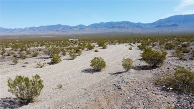 Right view of the dirt road that curbs with mountain view.