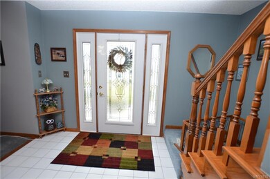 Large entryway with ceramic tile and leaded glass 