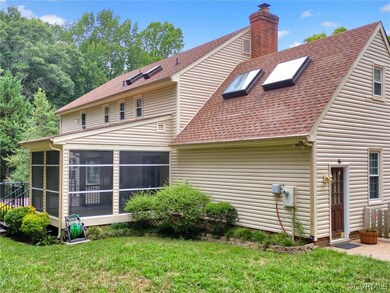 Rear view of property featuring a sunroom and a ya