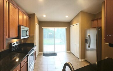 LARGE OPEN KITCHEN WITH PLENTY OF WOOD CABINETS AN