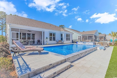 View of pool featuring a pool with connected hot t