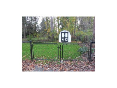 Fenced in backyard with tool/storage shed