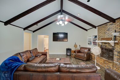 Living room featuring wood-type flooring, built in