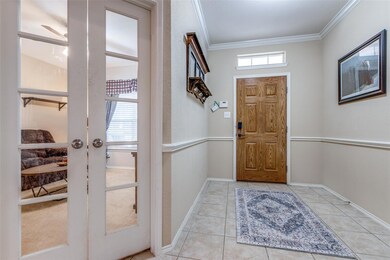 Tiled entryway featuring baseboards, ornamental mo