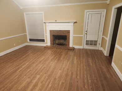 Unfurnished living room featuring hardwood / wood-