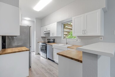 Kitchen featuring wooden counters, appliances wit