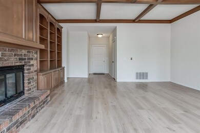 Unfurnished living room featuring coffered ceiling