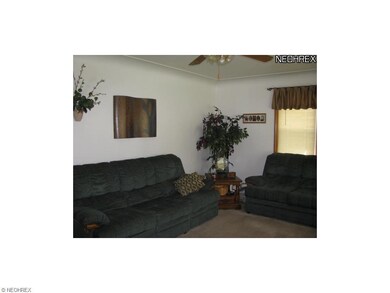 Spacious living room has newer carpet (1 yr).