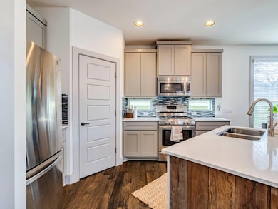 Kitchen with dark wood-type flooring, light count