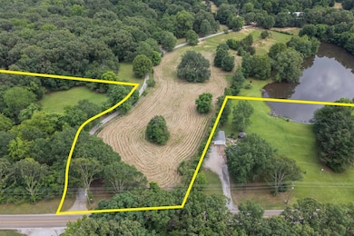 Aerial view of property and surrounding area with a large body of water and property parcel outlined